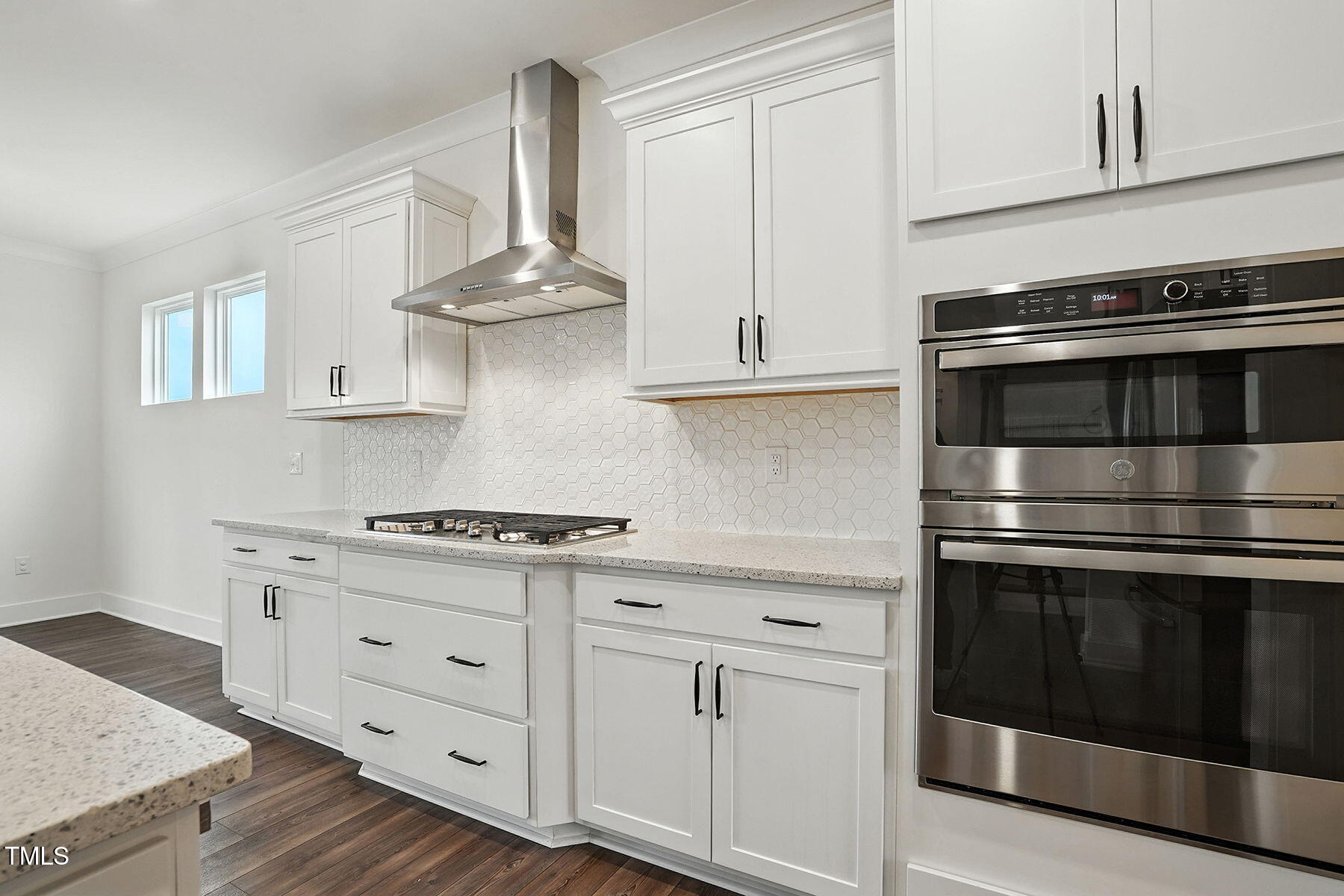 801 Mdw Frd Way Willow Spring, NC 27592 - Photo 5 of 36 a kitchen with white cabinets and stainless steel appliances