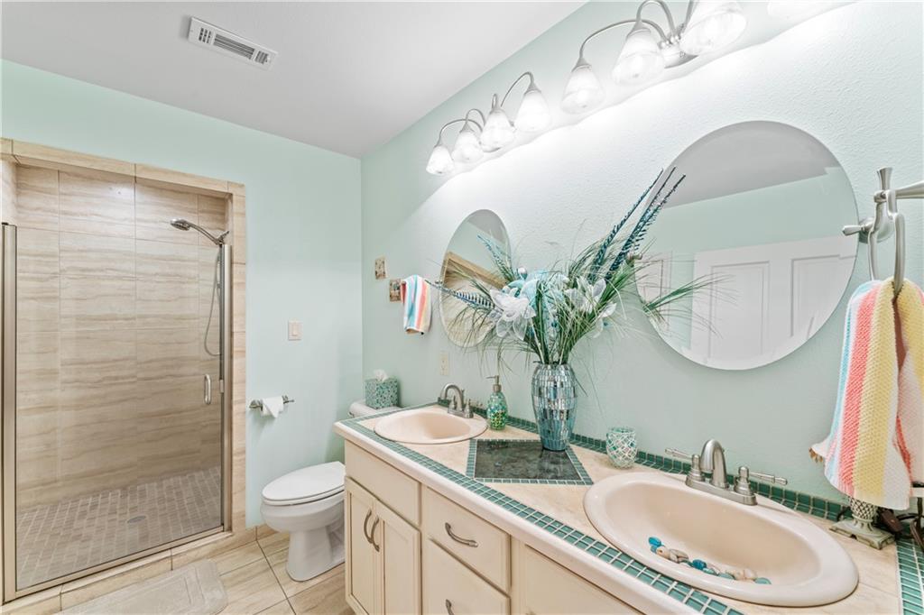 320 Holly Lane Walhalla, SC 29691 - Photo 36 of 41 This bathroom features a double vanity and a glass-enclosed shower, creating a bright and functional space.