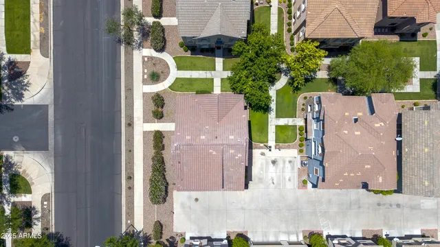 an aerial view of multiple houses with a yard