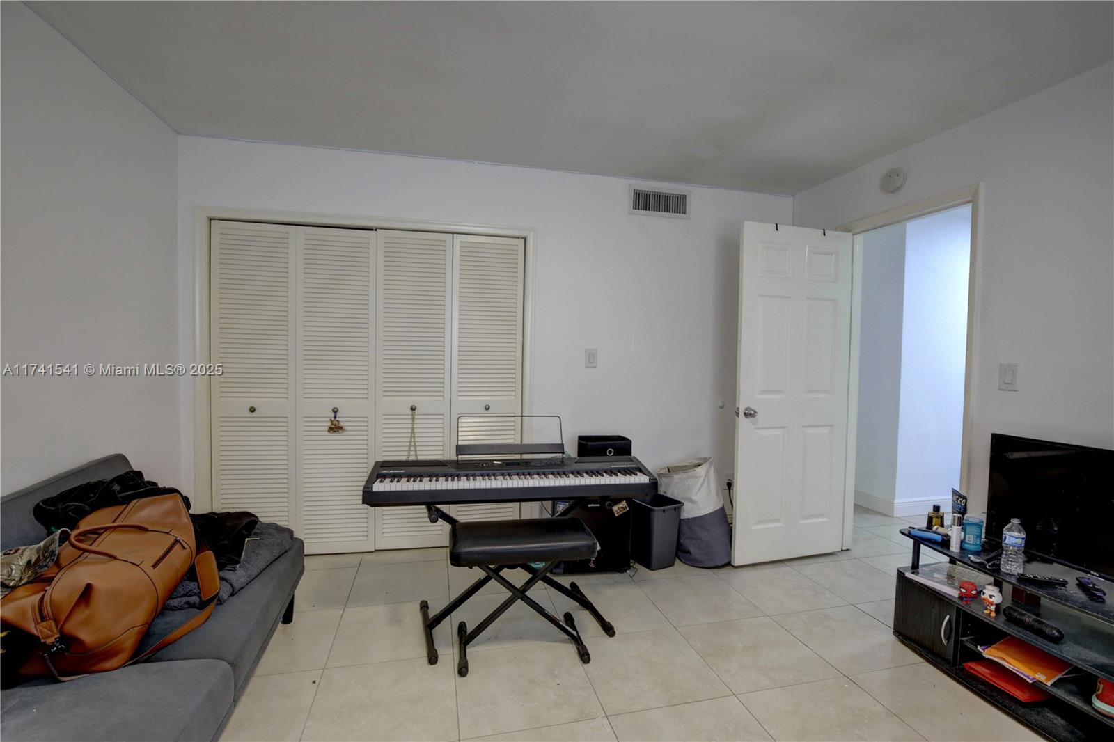 4995 Ponce De Leon Coral Gables, FL 33146 - Photo 25 of 92 a room with furniture and a flat screen tv