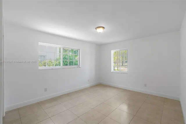 a bedroom with two beds and painted walls