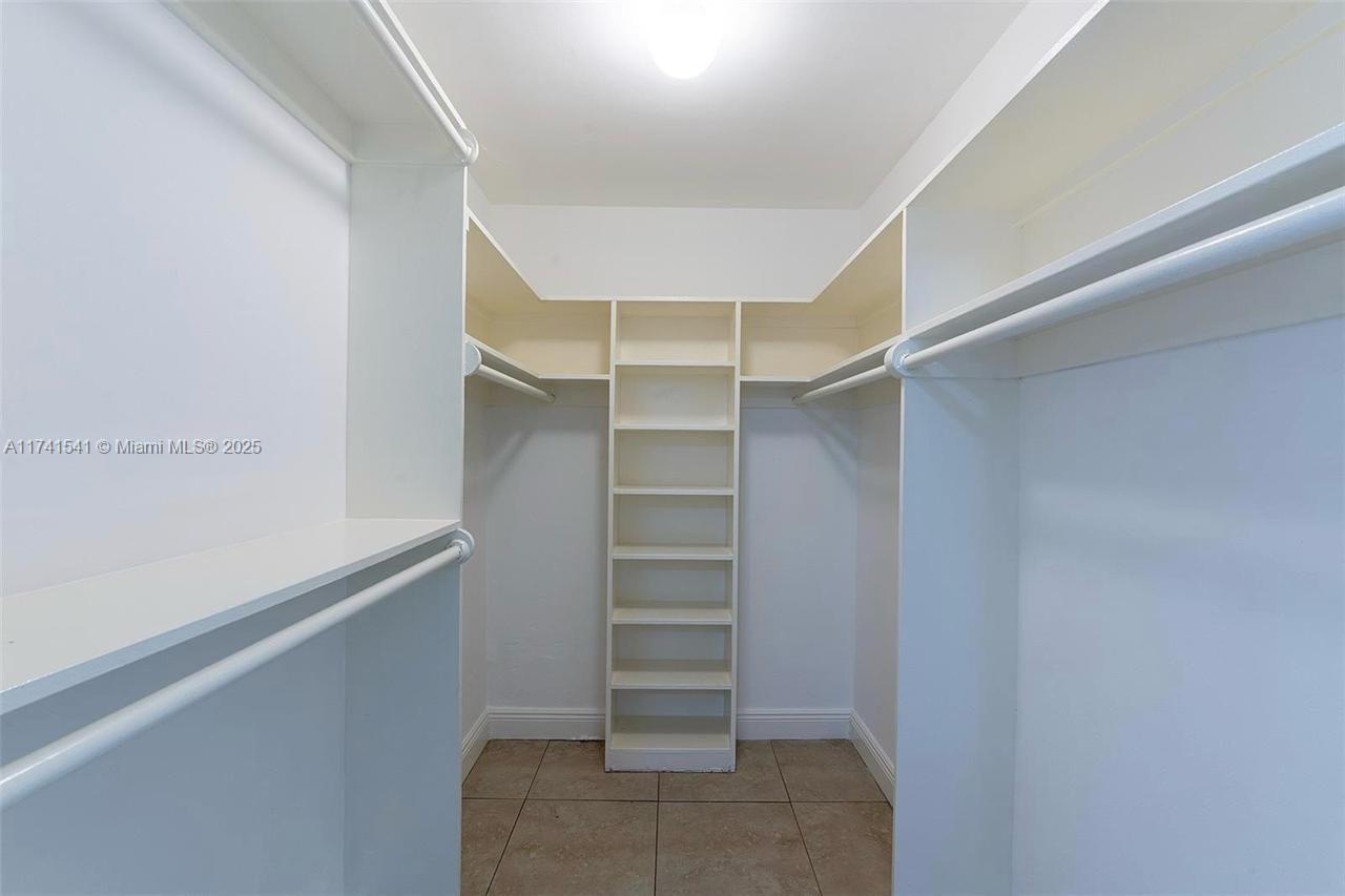 4995 Ponce De Leon Coral Gables, FL 33146 - Photo 47 of 92 a view of walk in closet with empty racks