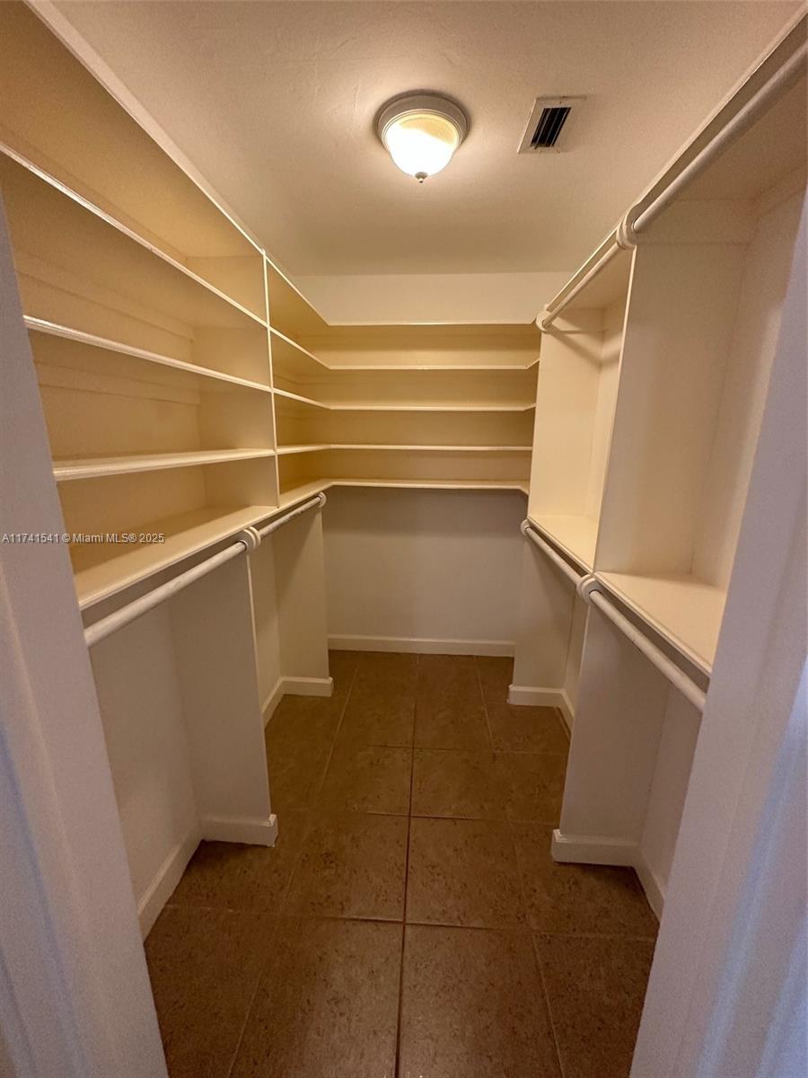 4995 Ponce De Leon Coral Gables, FL 33146 - Photo 54 of 92 a view of walk in closet with empty racks