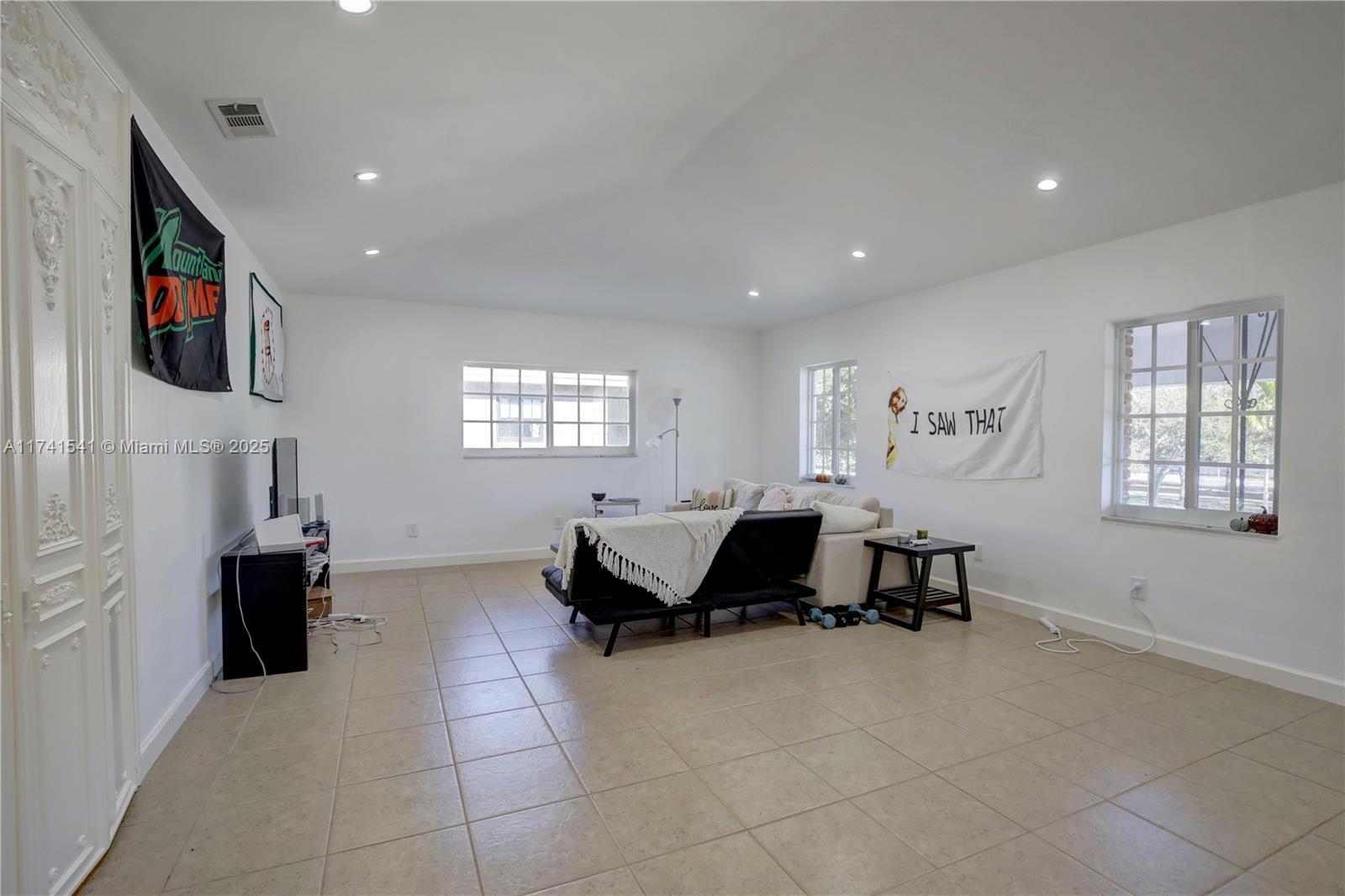 4995 Ponce De Leon Coral Gables, FL 33146 - Photo 65 of 92 a living room with furniture and a flat screen tv