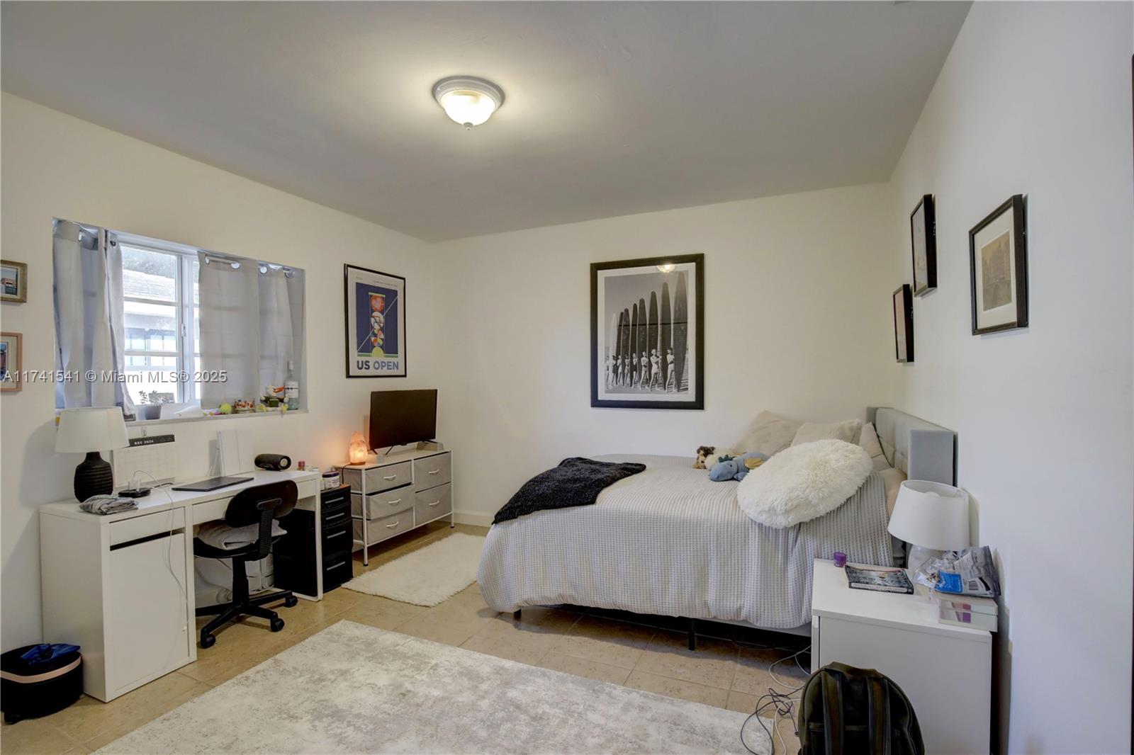 4995 Ponce De Leon Coral Gables, FL 33146 - Photo 74 of 92 a bedroom with a bed and a window