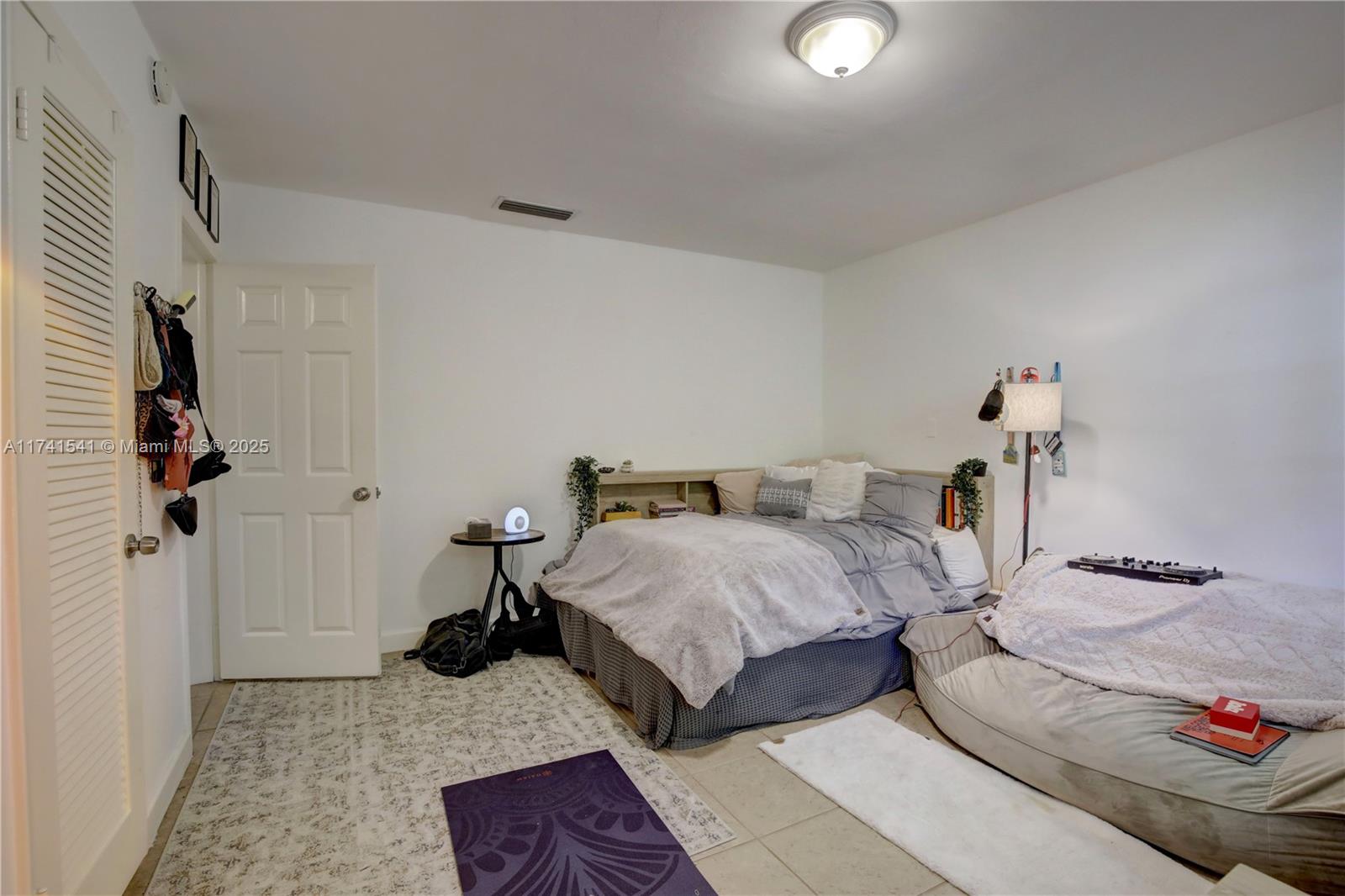 4995 Ponce De Leon Coral Gables, FL 33146 - Photo 79 of 92 a bedroom with two beds and painted walls