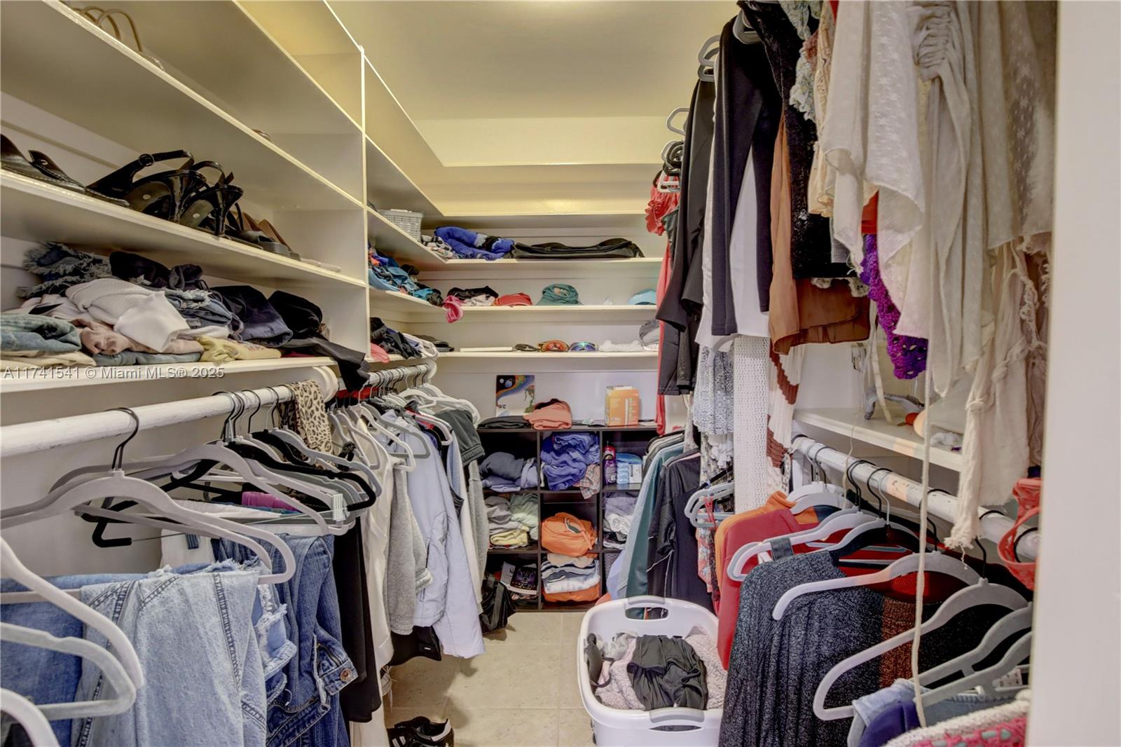 4995 Ponce De Leon Coral Gables, FL 33146 - Photo 81 of 92 a view of walk in closet with clothes and shoes