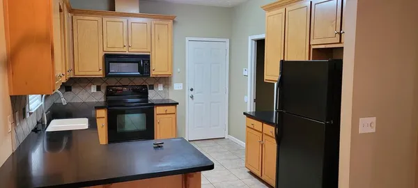 a kitchen with stainless steel appliances a refrigerator stove and microwave