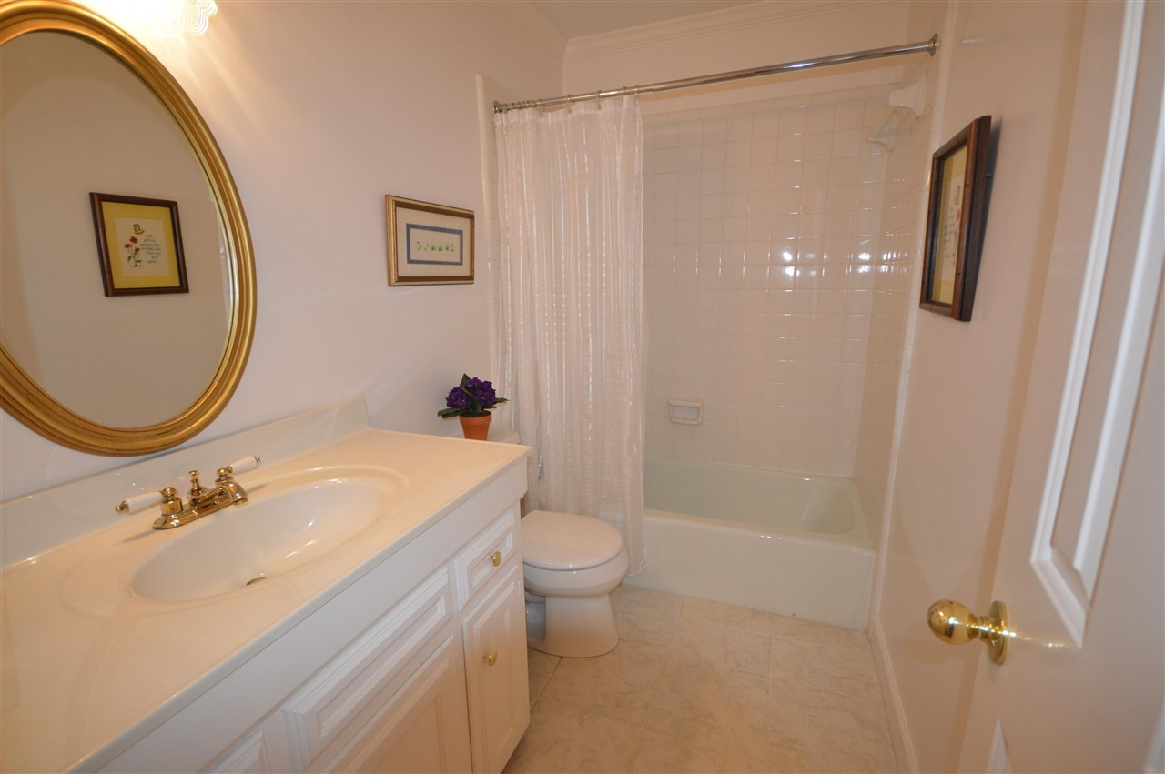 2929 Buckingham Road Durham, NC 27707 - Photo 14 of 26 a bathroom with a sink a toilet and shower