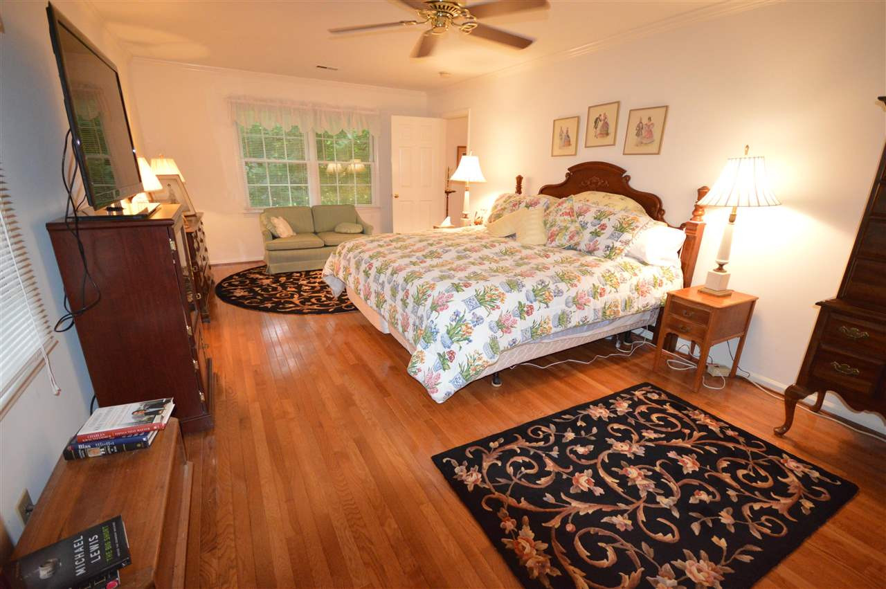 2929 Buckingham Road Durham, NC 27707 - Photo 15 of 26 a bedroom with a bed and wooden floor