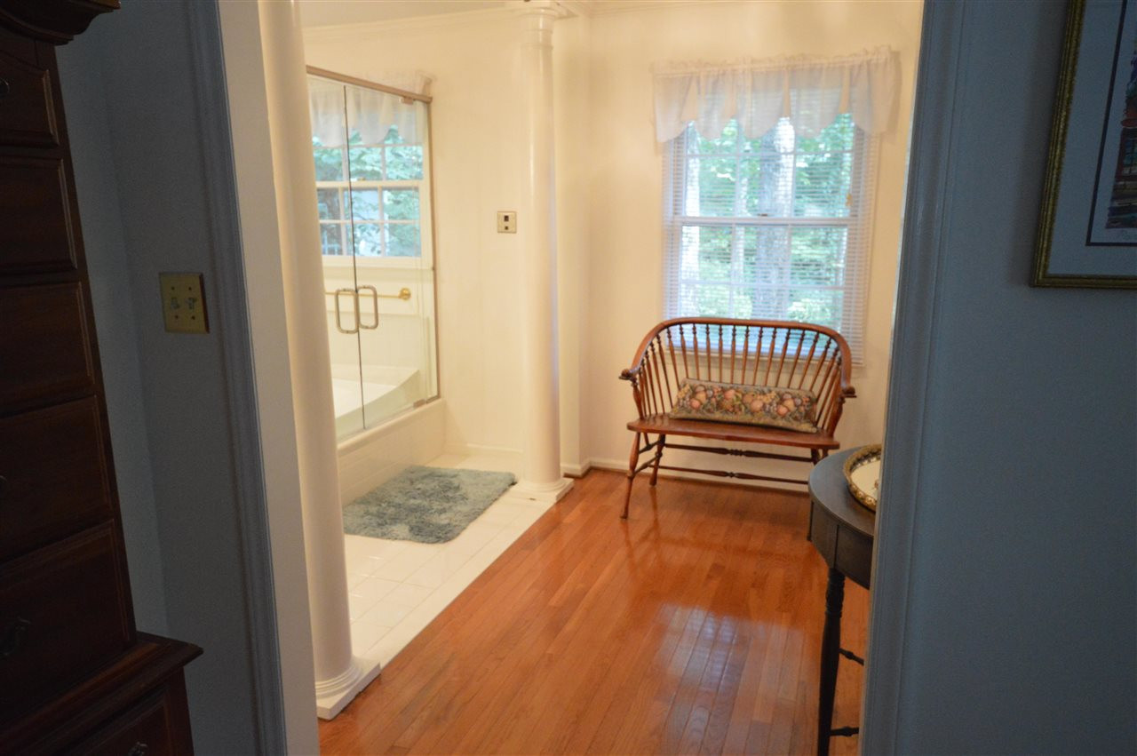 2929 Buckingham Road Durham, NC 27707 - Photo 16 of 26 a view of a bedroom with wooden floor and a window