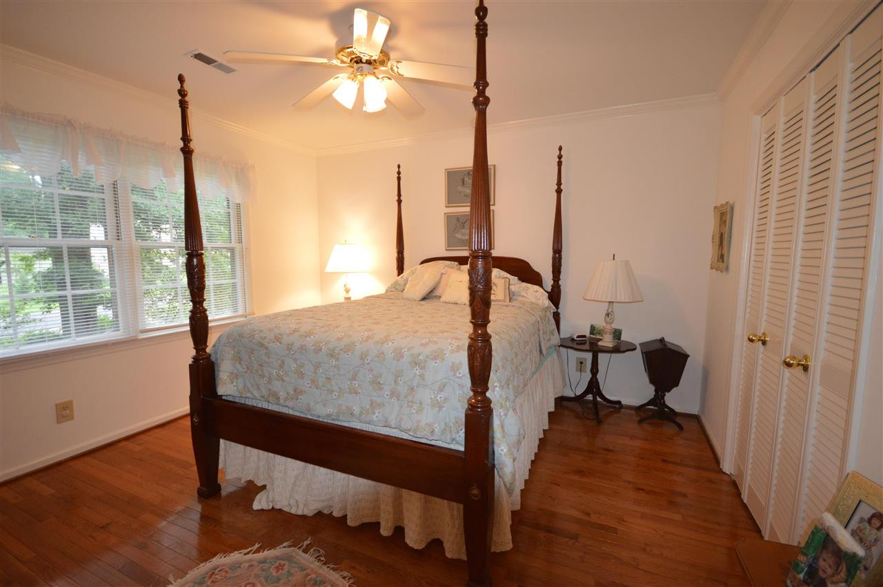 2929 Buckingham Road Durham, NC 27707 - Photo 21 of 26 a bedroom with a bed window and wooden floor