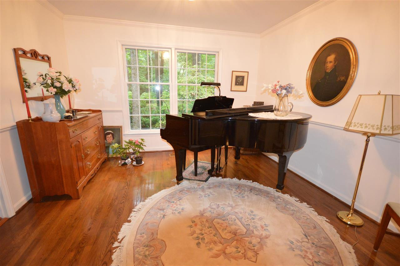 2929 Buckingham Road Durham, NC 27707 - Photo 8 of 26 a living room with furniture a rug potted plant and a large window