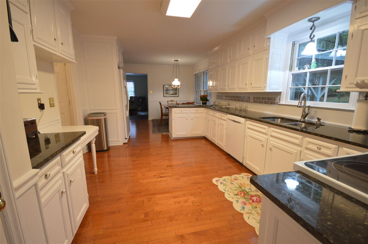 2929 Buckingham Road Durham, NC 27707 - Photo 9 of 26 a kitchen with stainless steel appliances granite countertop a sink stove and cabinets