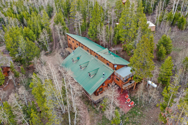 4725 Pine Ridge Road Evanston, UT 82930 - Photo 77 of 82 Expansive property featuring a multi-level wood-sided structure with a green metal roof