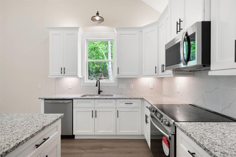 110 Doris Path Temple, GA 30179 - Photo 12 of 35 a kitchen with stainless steel appliances granite countertop a sink stove and cabinets