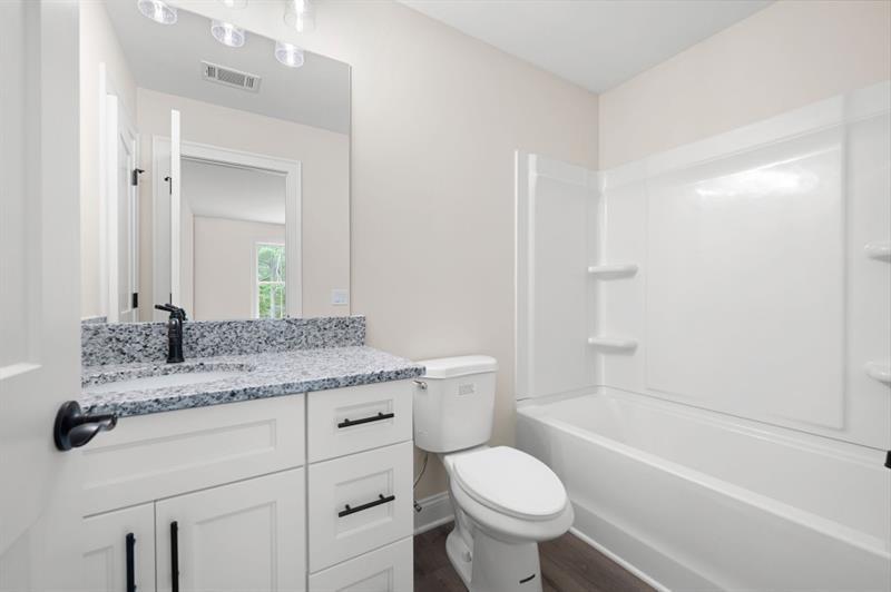 110 Doris Path Temple, GA 30179 - Photo 29 of 35 a bathroom with a granite countertop toilet a sink and a bathtub