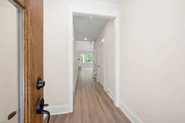 a view of a room with wooden floor
