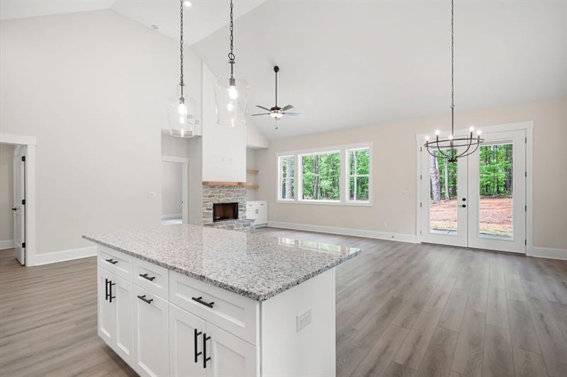110 Doris Path Temple, GA 30179 - Photo 10 of 35 a kitchen with kitchen island white cabinets and wooden floor