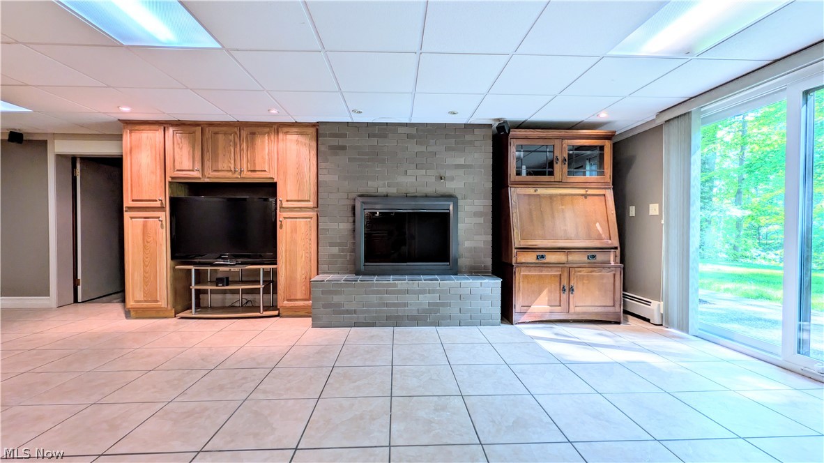 6409 Old Woods Road Ashtabula, OH 44004 - Photo 24 of 43 Tile flooring throughout, featuring a brick fireplace with a raised hearth