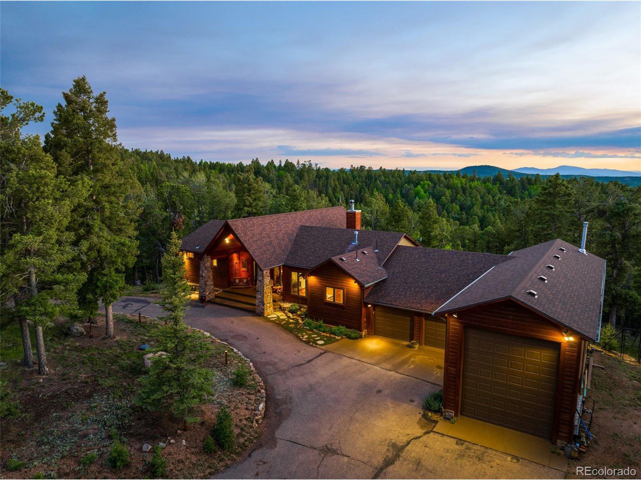 The front of the home with circular drive and lighted island landscaping