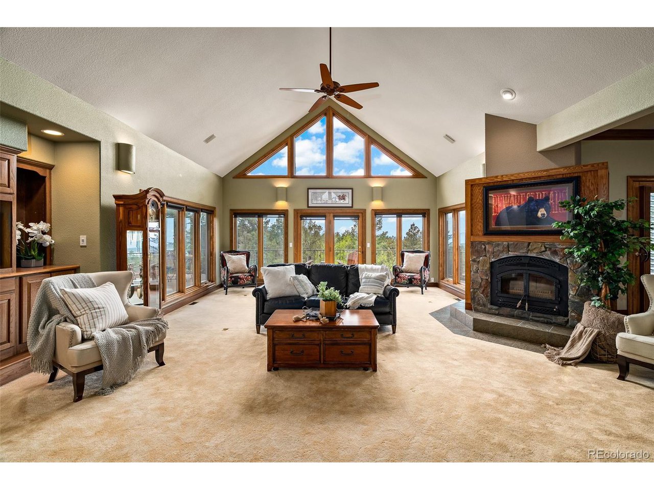 2755 Elk Ridge Divide Divide, CO 80814 - Photo 11 of 50 Living room with soaring vaulted ceilings, wood-burning fireplace, and an open concept with main-level access to the dining room, kitchen, primary suite, and walkout to the new rear composite deck with stunning views of the Front Range