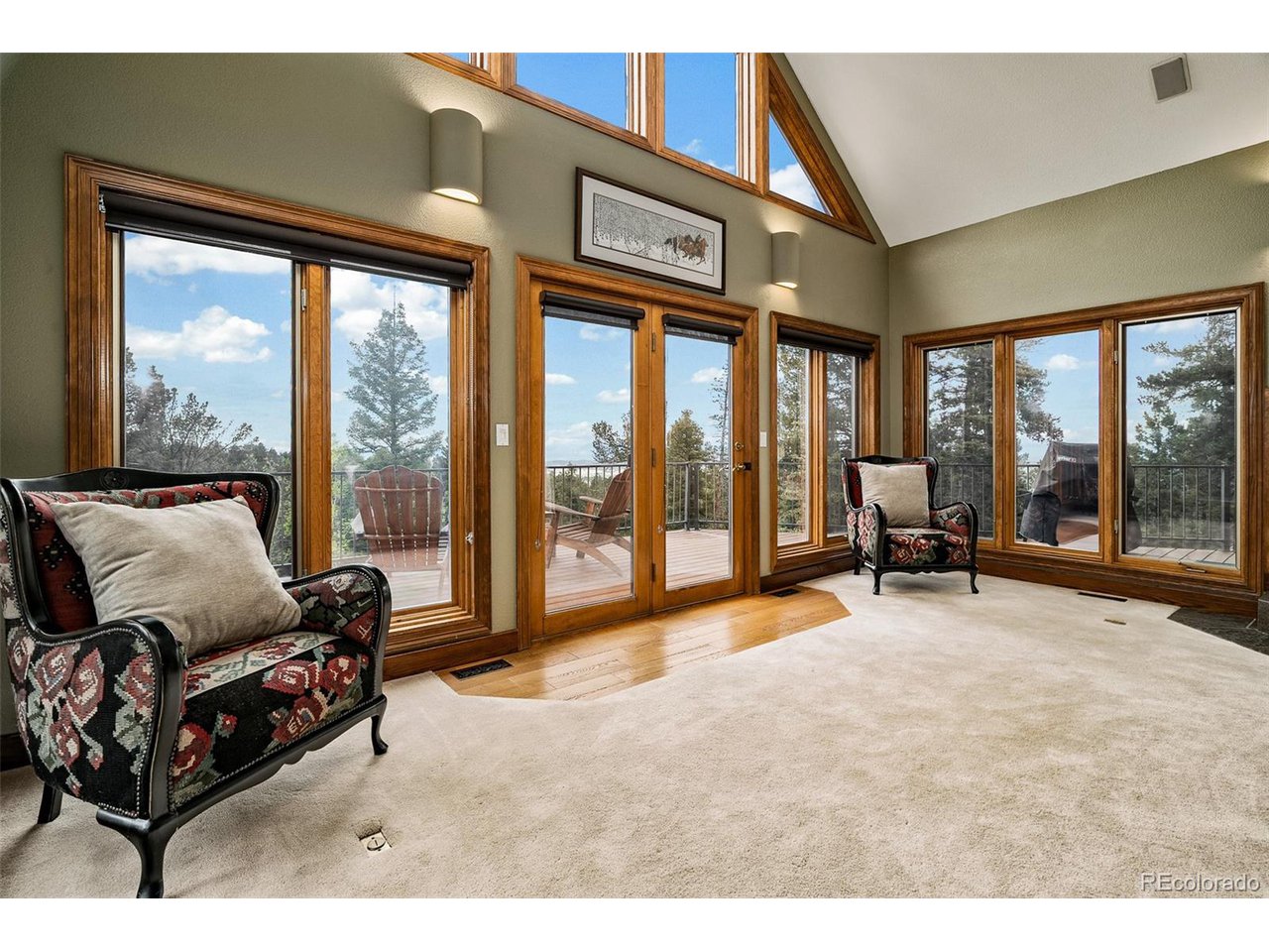 2755 Elk Ridge Divide Divide, CO 80814 - Photo 12 of 50 Living room featuring soaring vaulted ceilings, a wood-burning fireplace, and stunning views of the Front Range