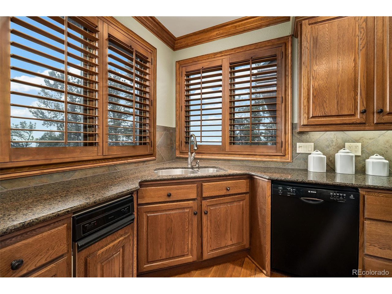 2755 Elk Ridge Divide Divide, CO 80814 - Photo 15 of 50 Eat-in kitchen island with granite counters, tons of storage, architectural moulding, and a walkout to the new composite deck and gorgeous views of the Front Range