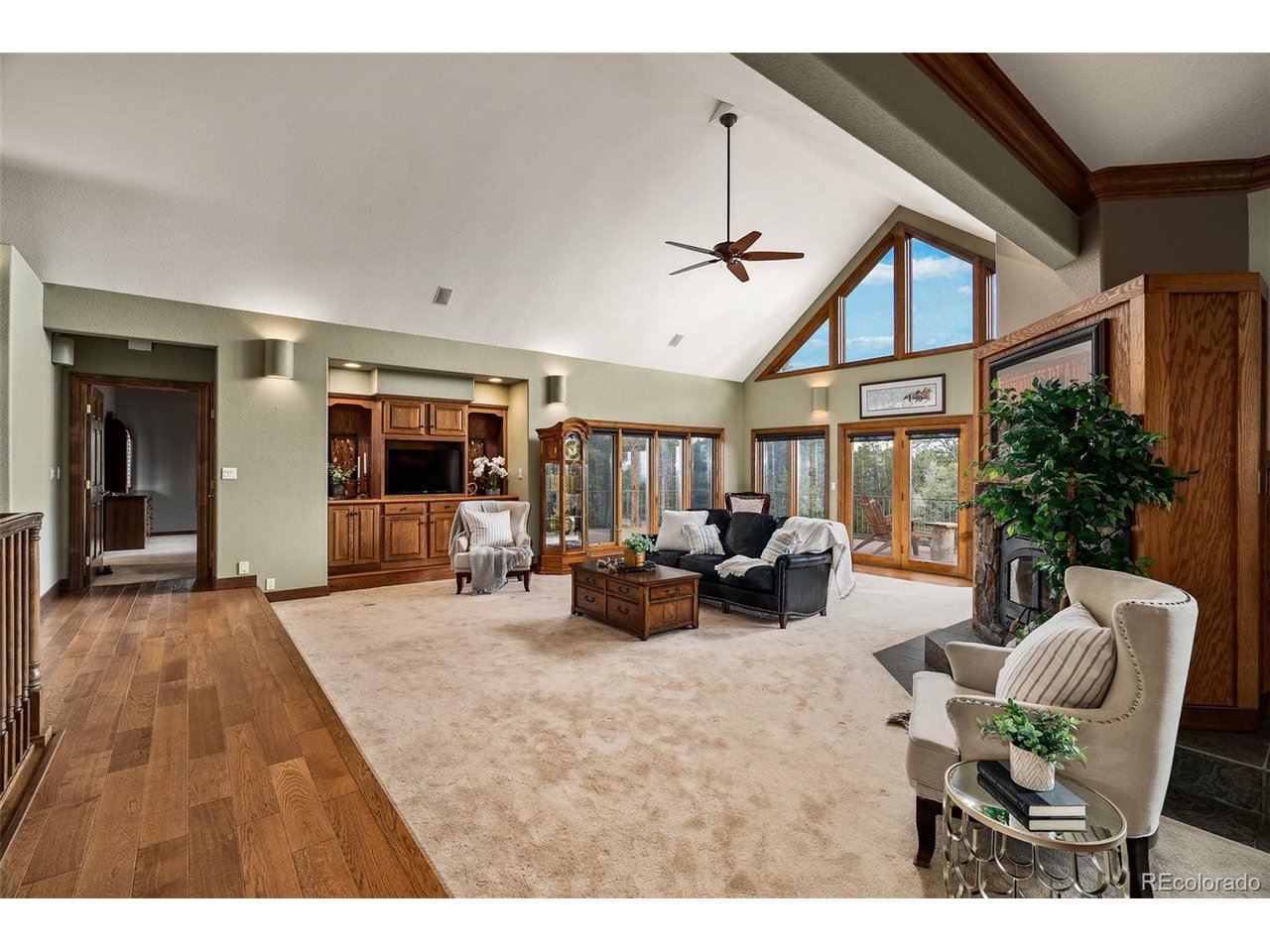 2755 Elk Ridge Divide Divide, CO 80814 - Photo 19 of 50 Living room with soaring vaulted ceilings, wood-burning fireplace, and an open concept with main-level access to the dining room, kitchen, primary suite, and walkout to the new rear composite deck with stunning views of the Front Range