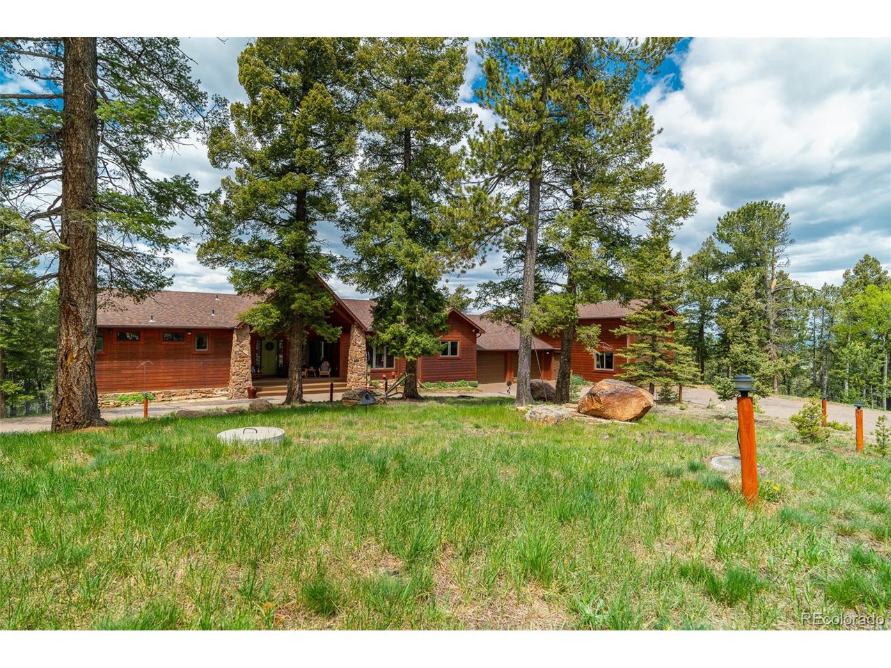2755 Elk Ridge Divide Divide, CO 80814 - Photo 4 of 50 Front yard with level, circular driveway around center landscape feature