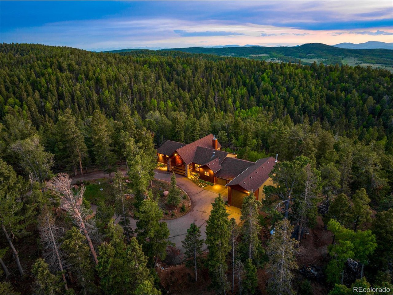 2755 Elk Ridge Divide Divide, CO 80814 - Photo 49 of 50 Aerial view of the front of the home at dusk