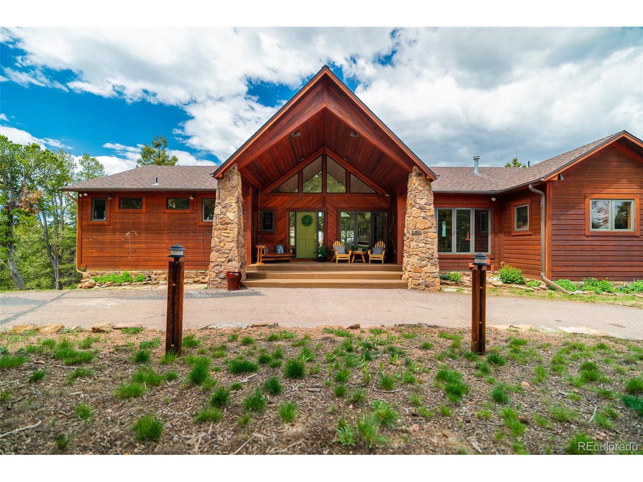 2755 Elk Ridge Divide Divide, CO 80814 - Photo 6 of 50 View of front of home with large front deck and picture windows