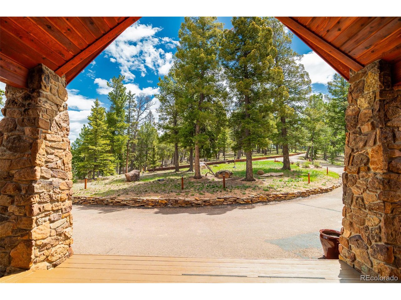 2755 Elk Ridge Divide Divide, CO 80814 - Photo 7 of 50 View from large covered front deck out to level, circular driveway