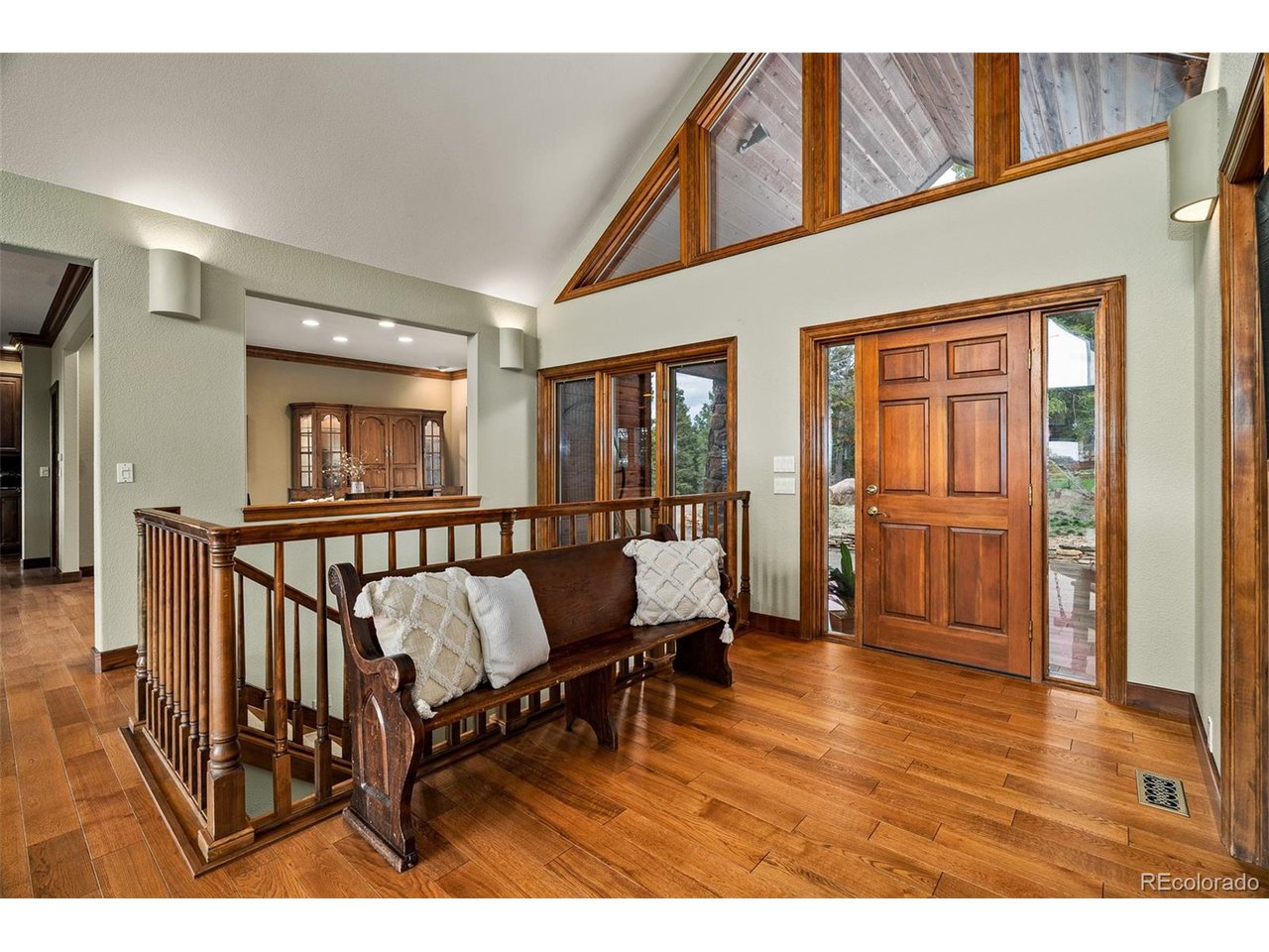 2755 Elk Ridge Divide Divide, CO 80814 - Photo 9 of 50 Spacious foyer entrance featuring soaring vaulted ceilings, sitting area, powder room, and hardwood flooring