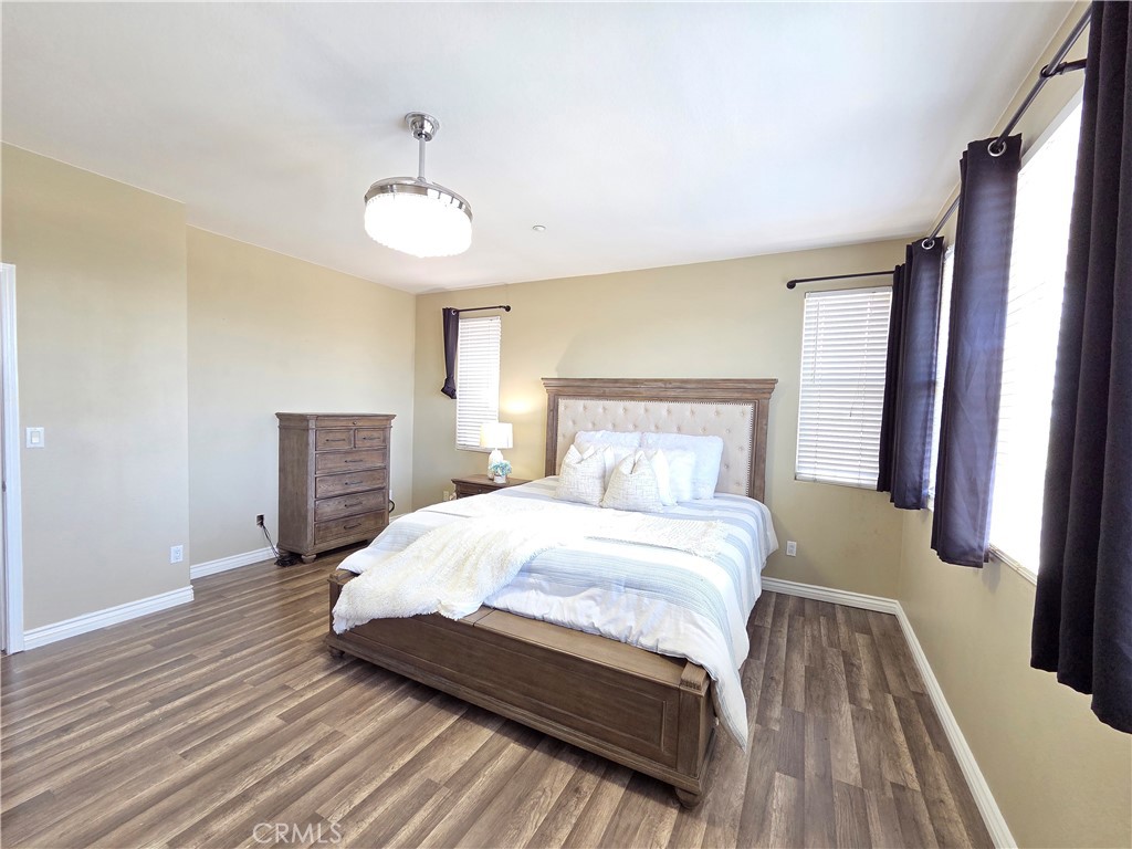 20329 Red Poppy Lane Riverside, CA 92508 - Photo 15 of 24 a bedroom with a bed and wooden floor