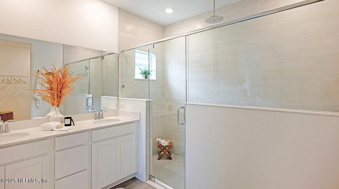 36 Bluegrass Way St. Augustine, FL 32092 - Photo 15 of 40 a bathroom with a double vanity sink and a mirror