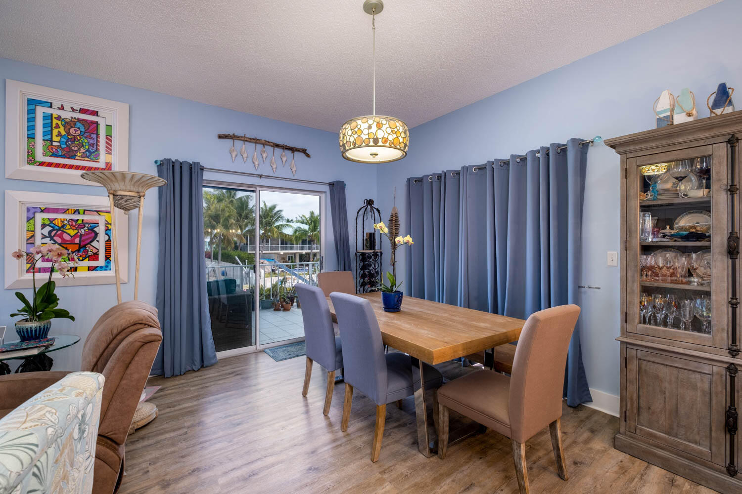 16 Corrine Place Key Largo, FL 33037 - Photo 14 of 50 a view of a dining room with furniture wooden floor and a chandelier