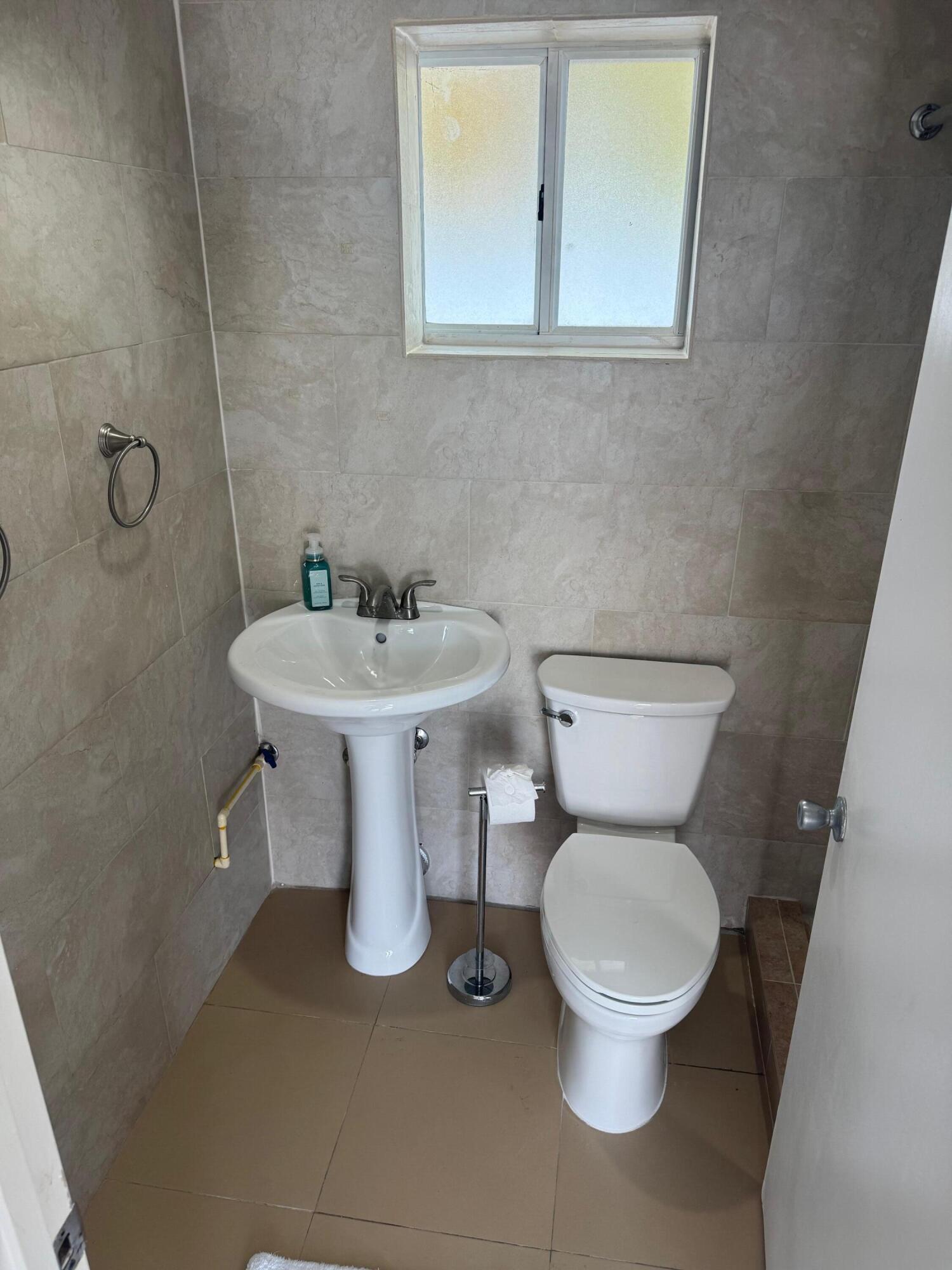 16 Corrine Place Key Largo, FL 33037 - Photo 35 of 50 a white toilet sitting next to a bathroom sink
