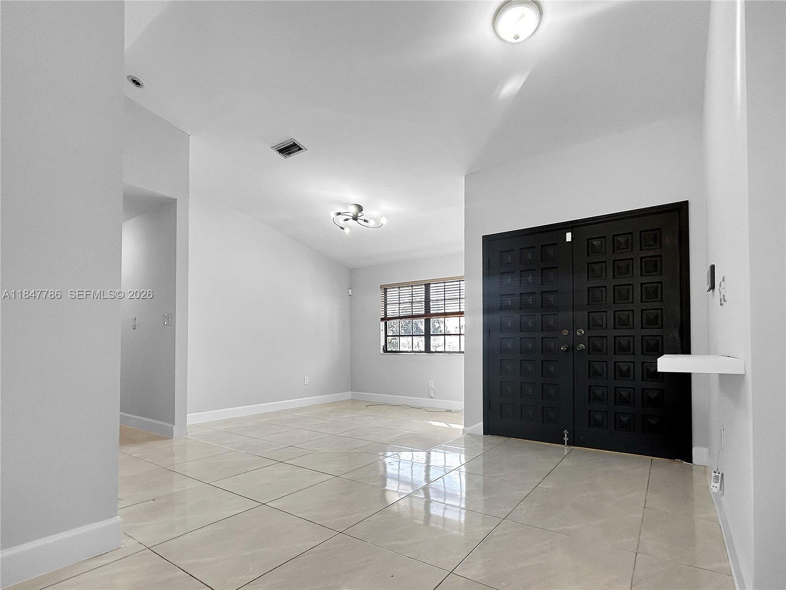 13925 Southwest 26th Terrace Miami, FL 33175 - Photo 11 of 42 a view of an empty room and window