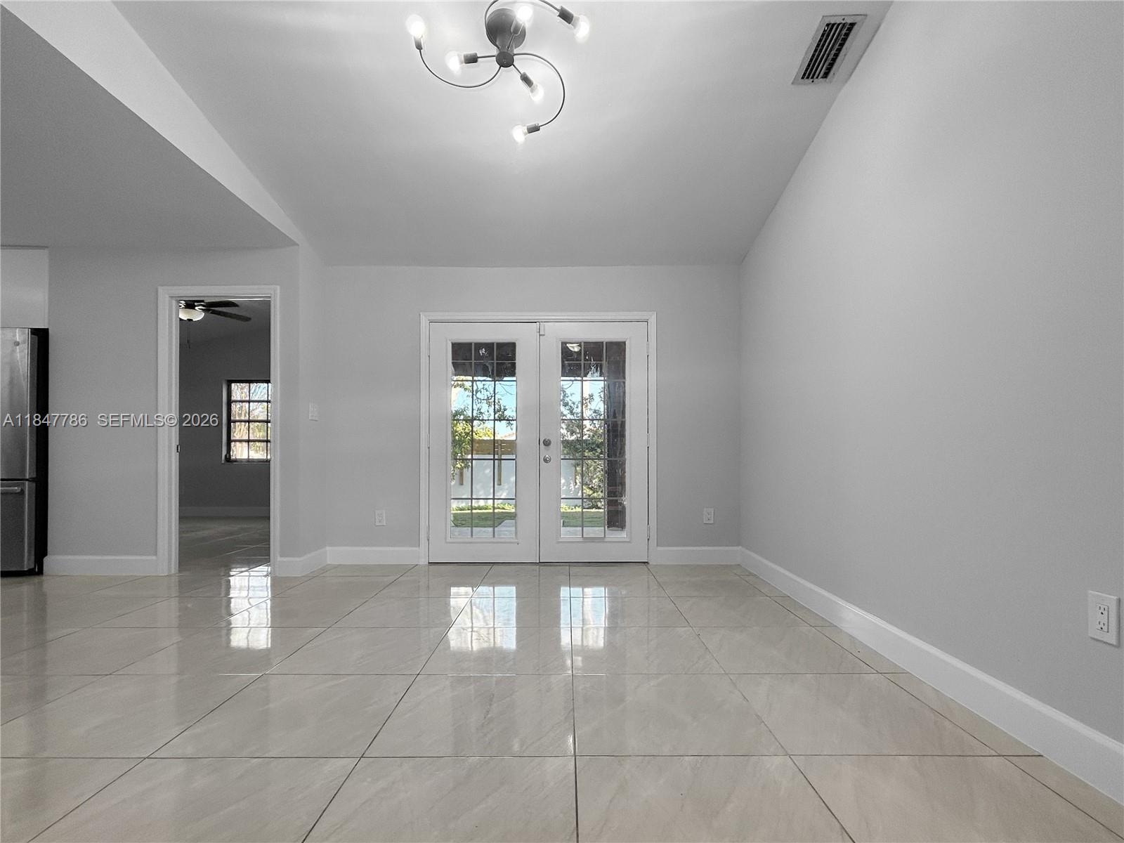 13925 Southwest 26th Terrace Miami, FL 33175 - Photo 14 of 42 a view of an empty room with glass door