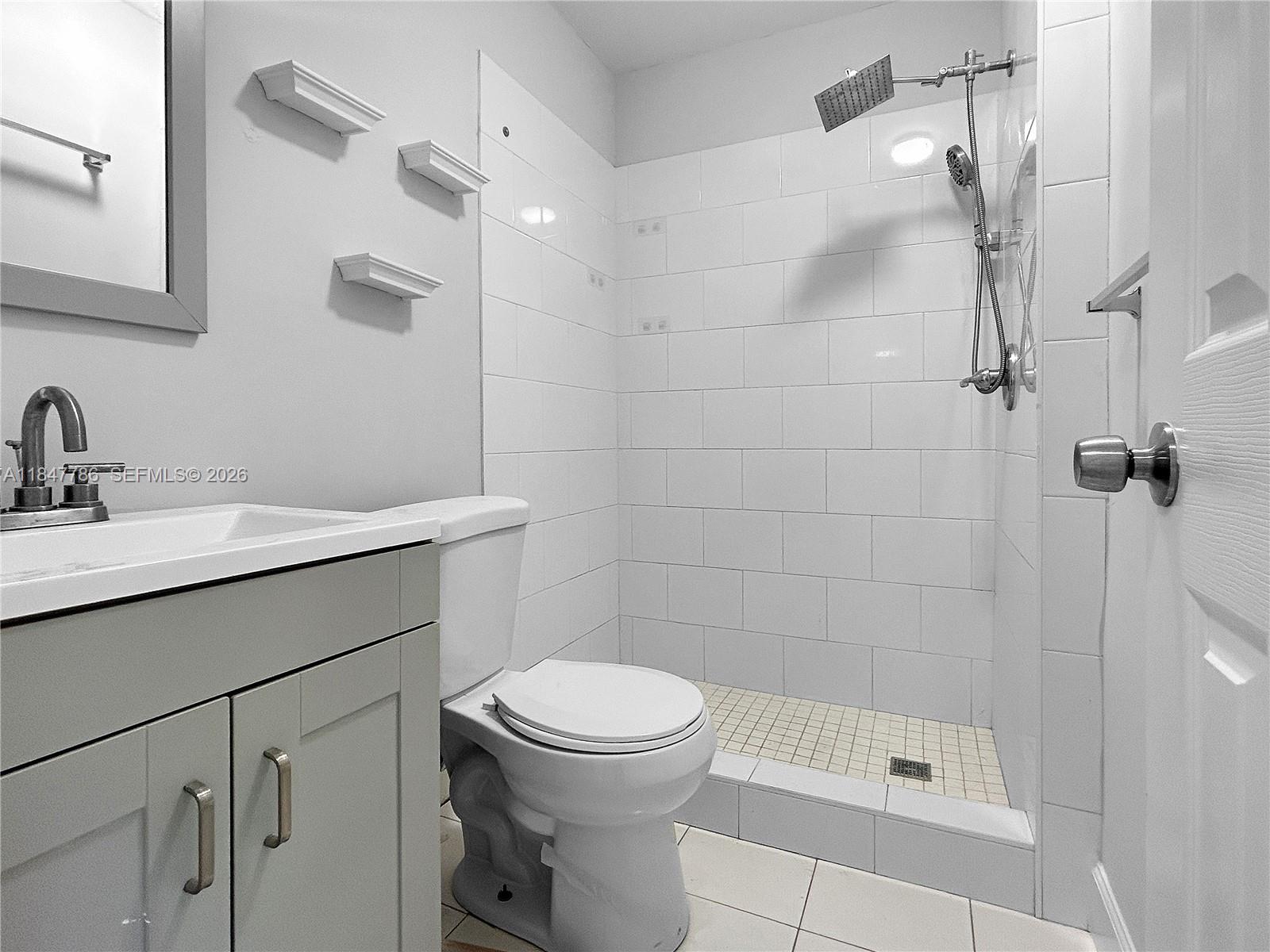 13925 Southwest 26th Terrace Miami, FL 33175 - Photo 17 of 42 a bathroom with a sink a toilet and shower
