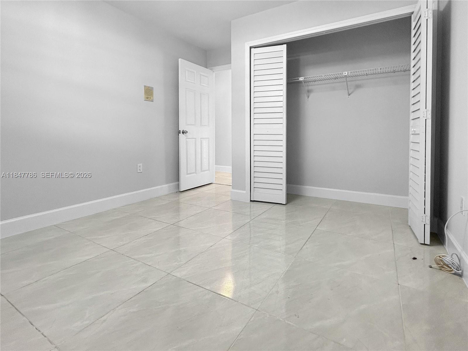13925 Southwest 26th Terrace Miami, FL 33175 - Photo 19 of 42 an empty room with a empty space