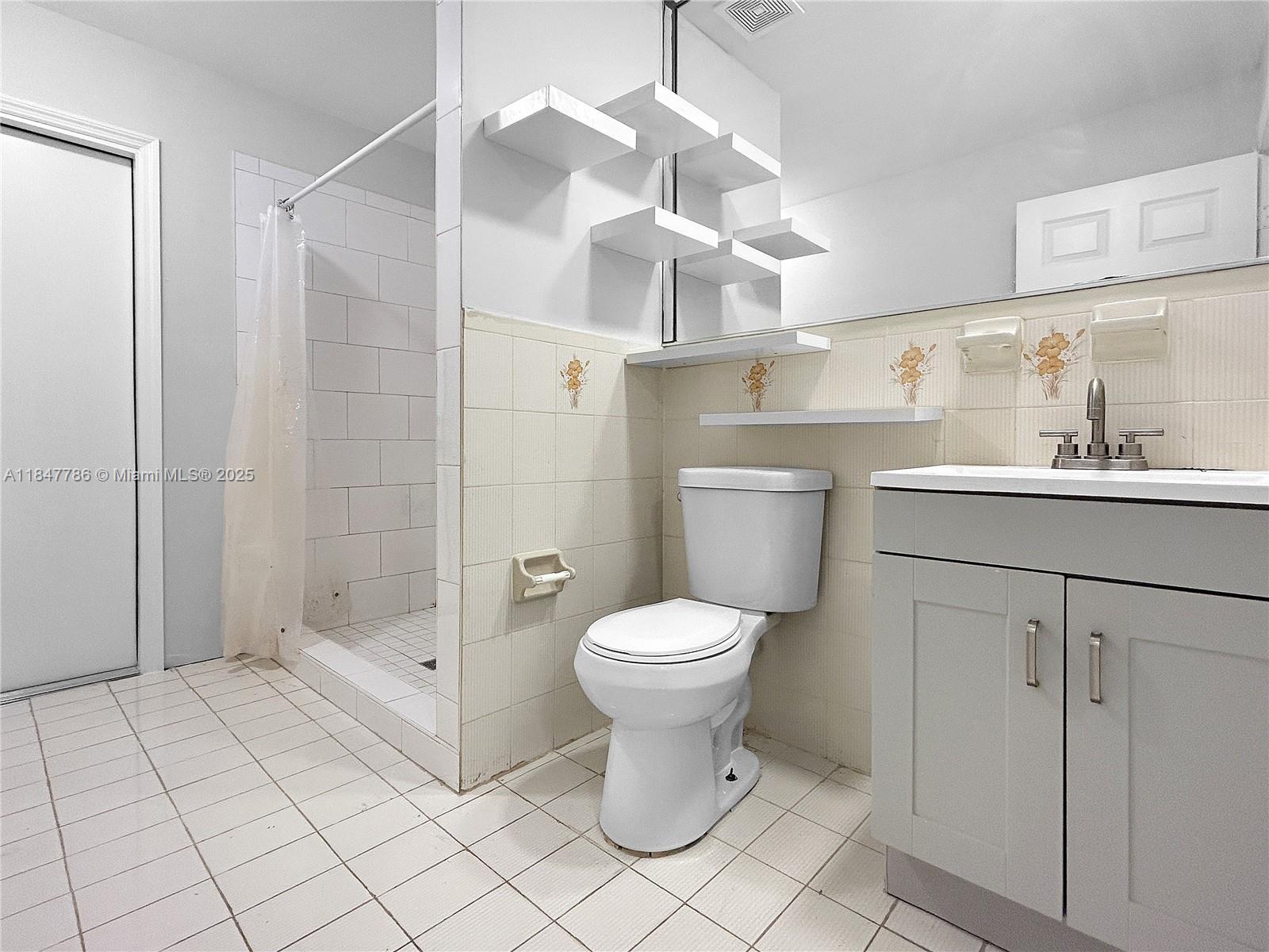 13925 Southwest 26th Terrace Miami, FL 33175 - Photo 19 of 36 a bathroom with a sink toilet and shower