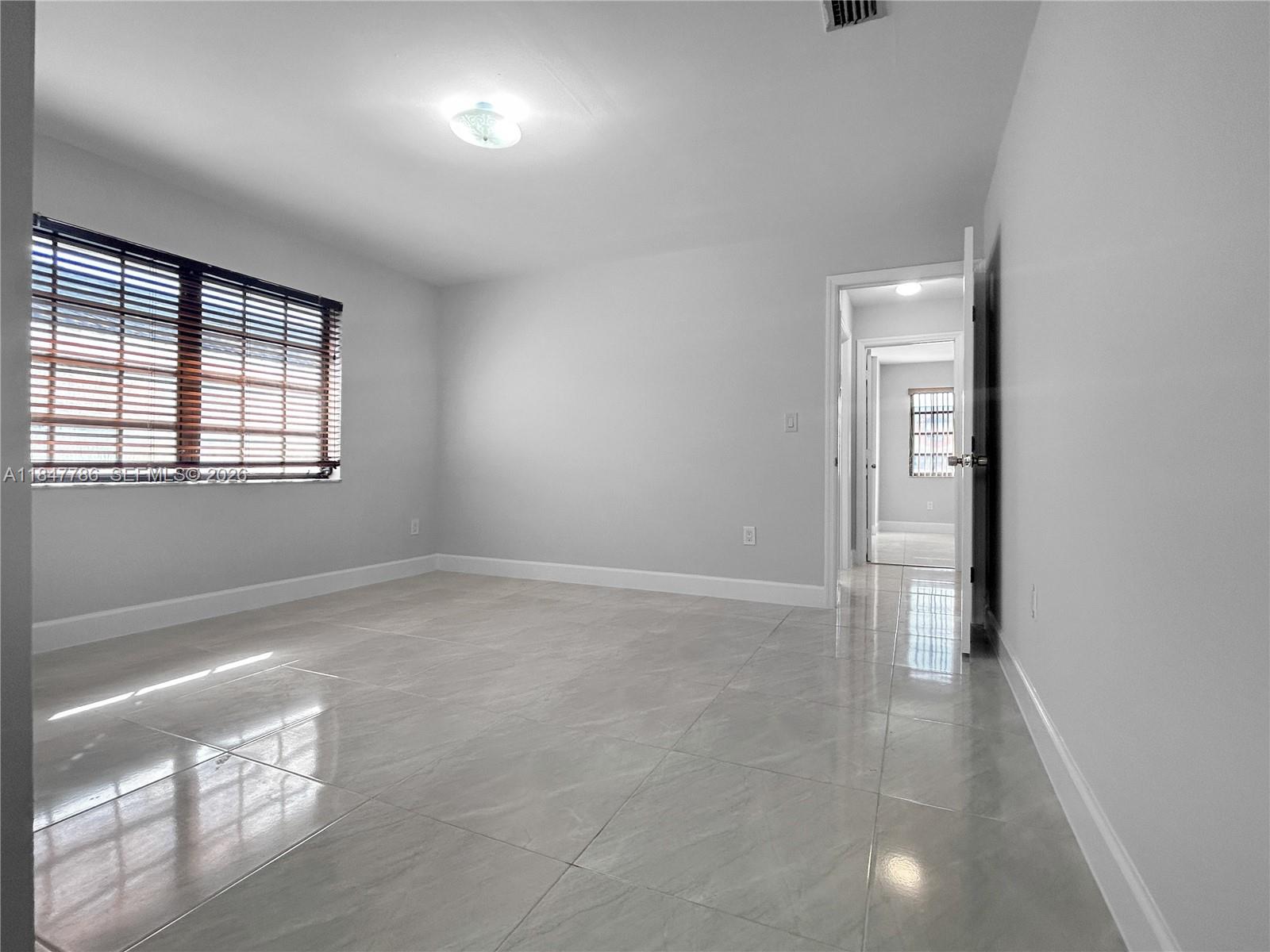 13925 Southwest 26th Terrace Miami, FL 33175 - Photo 20 of 42 an empty room with windows and closet