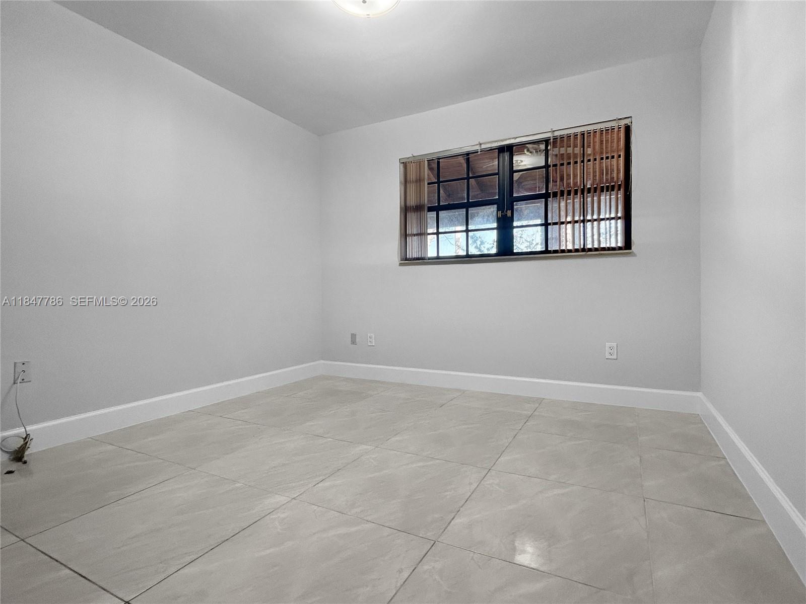 13925 Southwest 26th Terrace Miami, FL 33175 - Photo 21 of 42 an empty room with windows