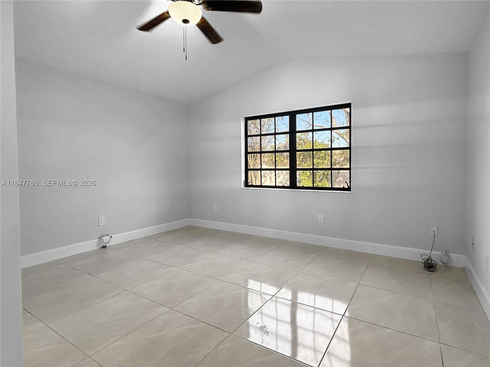 13925 Southwest 26th Terrace Miami, FL 33175 - Photo 22 of 42 wooden floor in an empty room with a window