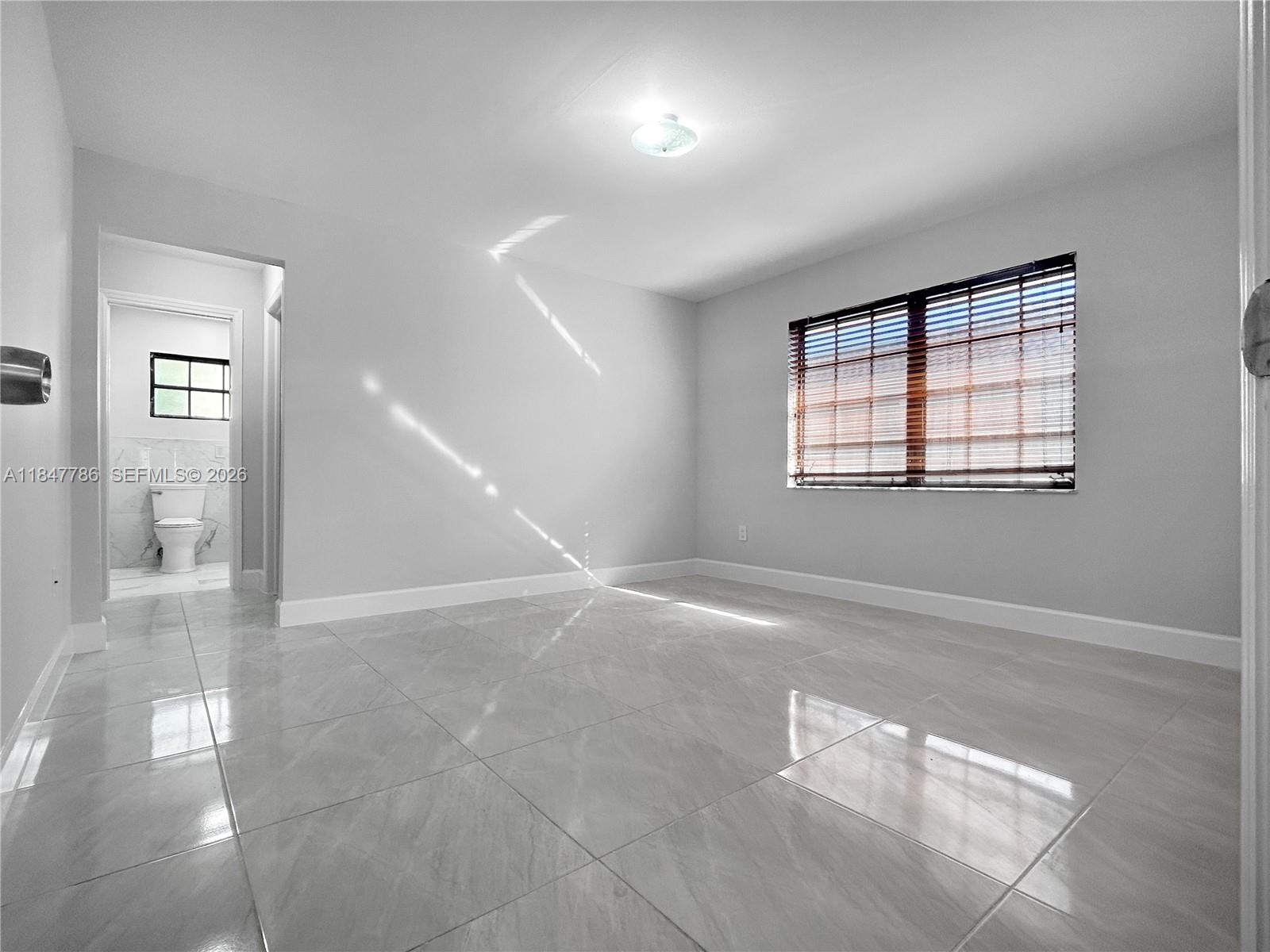 13925 Southwest 26th Terrace Miami, FL 33175 - Photo 25 of 42 a view of an empty room with a window