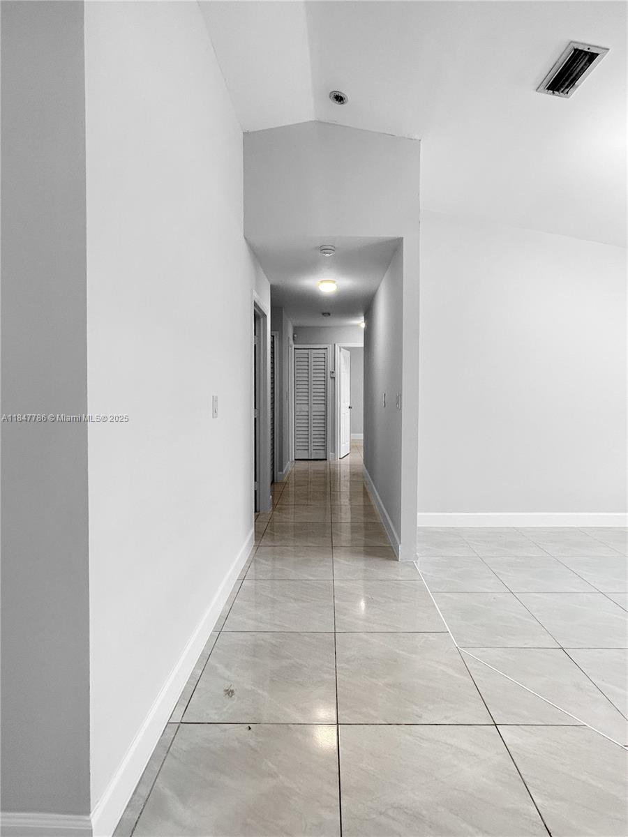 13925 Southwest 26th Terrace Miami, FL 33175 - Photo 27 of 36 a view of hallway with a rug and a window