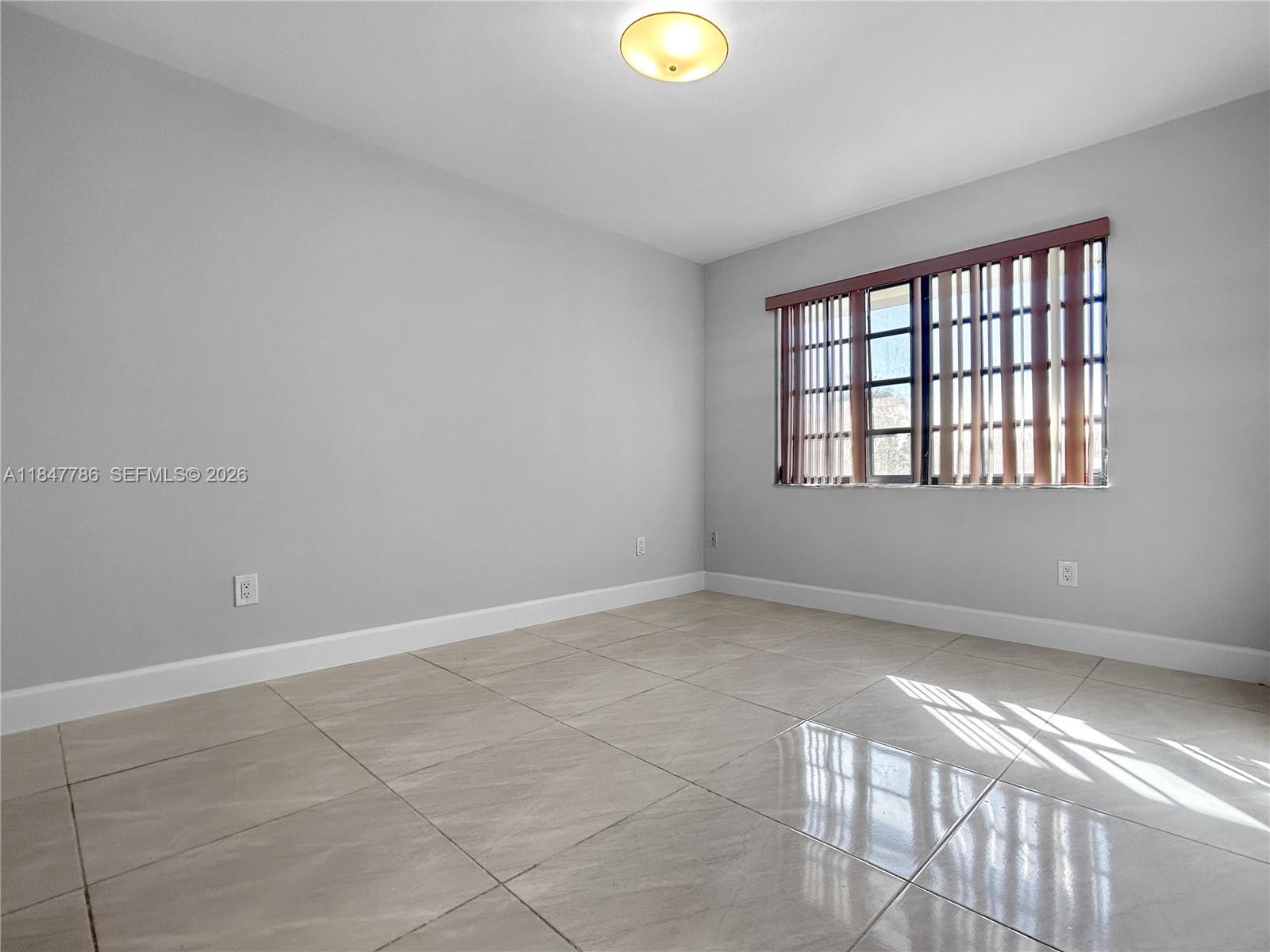 13925 Southwest 26th Terrace Miami, FL 33175 - Photo 29 of 42 a view of an empty room and window