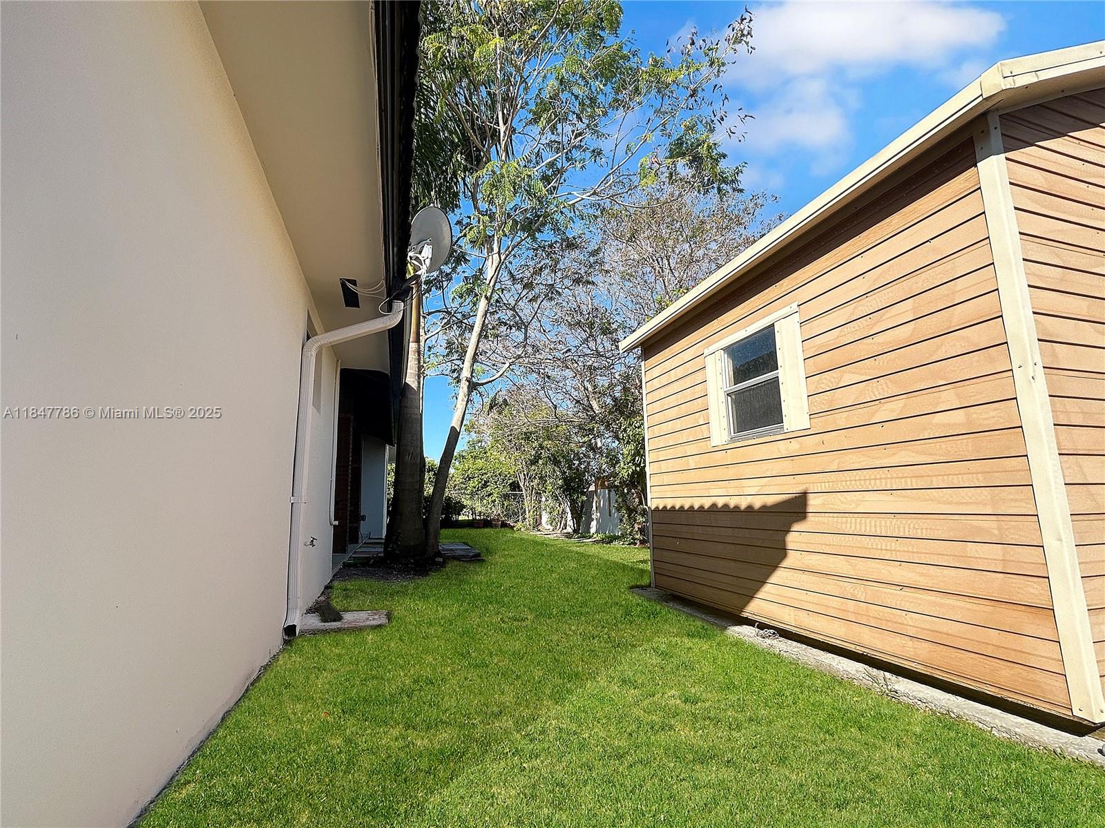 13925 Southwest 26th Terrace Miami, FL 33175 - Photo 32 of 36 a view of a backyard with potted plants and large tree